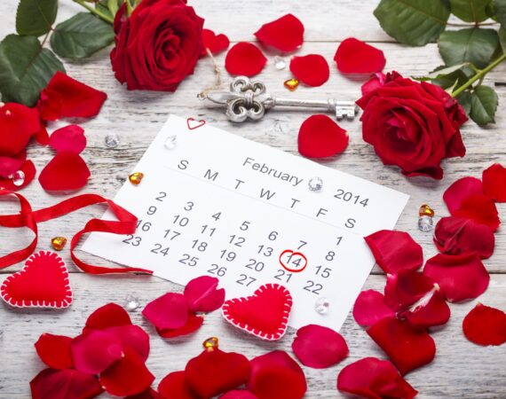 Calendar page with hearts, petals and ribbon on St.Valentines Day